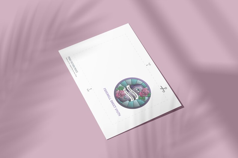 May include: Printable paper craft pattern for a round patch with a purple, blue, and green design. The patch features a tombstone with the text "Keep it mysterious" and two pink roses. The text "Farewell Sweet Youth" is printed below the patch.