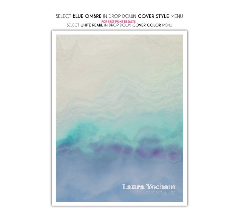May include: A framed print featuring an abstract design in blue, teal, and purple hues, with a white border. The text "Laura Yocham Appointments" is at the bottom. Instructions above the design advise selecting "Blue Ombre" and "White Pearl" from the dropdown menus.