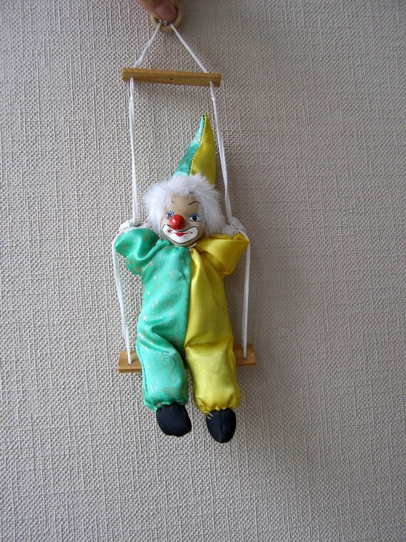 porcelain clown on swing