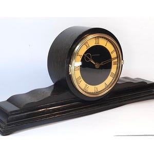 Wooden desk clock. Vintage mantel clock USSR 1950s. Mechanical watch. Old clock with key. Retro style Vesna plant clock.