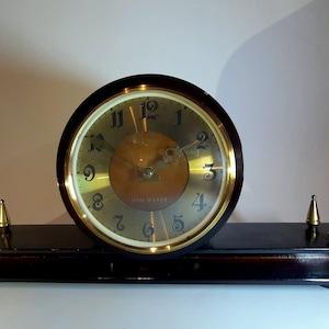 Wooden desk clock. Vintage mantel clock USSR 1950s. Mechanical watch. Old clock with key. Retro style Vesna plant clock.
