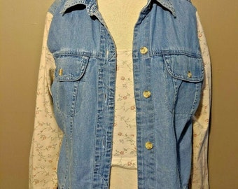 May include: A blue denim jacket with floral patterned sleeves. The jacket has a button-up front and two pockets.