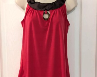 May include: A sleeveless red tank top with a black satin neckline and a decorative ring detail at the center neckline.