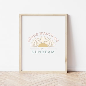 May include: A framed print with a sun graphic and the text "JESUS WANTS ME for a SUNBEAM" in pink, yellow, and blue.