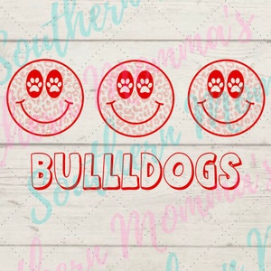 May include: Three red and white smiling faces with paw print eyes and the word "BULLDOGS" in red letters.
