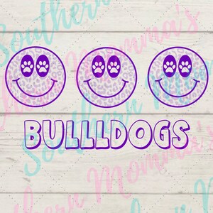 May include: Three purple and white leopard print smiley faces with paw print eyes and the word "BULLDOGS" in purple text below.