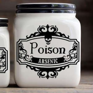May include: White ceramic jar with a black lid and a black and white label that says "Poison Arsenic" with a skull and crossbones design.