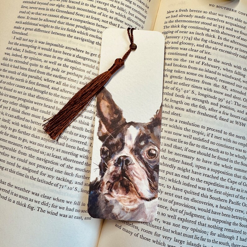 A bookmark showcasing a design from one of Alex's original paintings, featuring a Boston Terrier design. Printed on fine Italian card, it comes with a chocolate brown coloured tassel, packaged in a glassine bag, and finished with a stylish branded sticker.