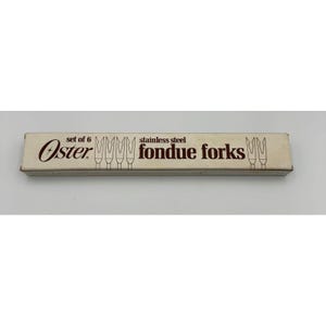 May include: A rectangular off-white cardboard box containing a set of 6 Oster stainless steel fondue forks. The box features brown text that reads "set of 6", "Oster", and "stainless steel fondue forks", along with line art illustrations of forks.