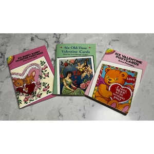 May include: A white ceramic mug with a black handle and the text "But First, Coffee" in a handwritten style. The mug is on a white surface. The mug is 4 inches tall.