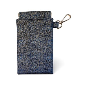 May include: A navy blue fabric case with a gold floral pattern. The case has a fold-over flap and a gold-coloured metal clasp. The case is designed to hold small items. The measurements are in centimetres.