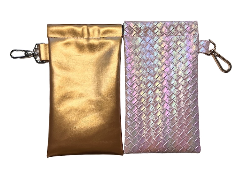 May include: Two small pouches with a gold clasp. The pouch on the left is gold and the pouch on the right is iridescent pink with a woven pattern.