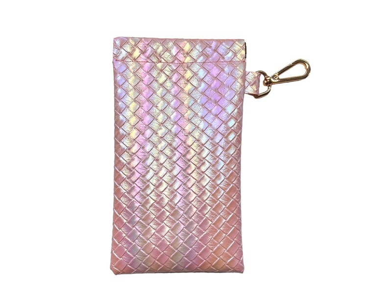 May include: A pink iridescent woven pouch with a gold zipper and a gold hook and loop closure. The pouch has a woven pattern and is perfect for storing small items.