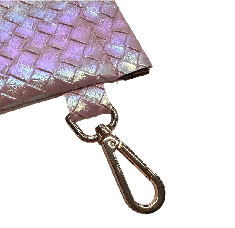 May include: A pink iridescent woven purse with a gold metal clasp and a gold metal hook.