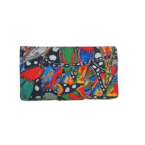 May include: A brightly patterned clutch bag with an abstract design. The pattern includes red, green, blue, and yellow shapes, with black detailing. The bag is rectangular with a flap and a button closure.