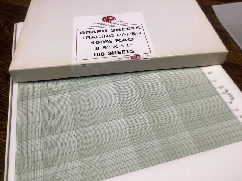 May include: A box of graph sheets with the text "GRAPH SHEETS TRACING PAPER 100% RAG 8.5" X 11" 100 SHEETS". The sheets are green and white with a grid pattern. The box is white.