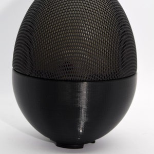 May include: Black egg-shaped essential oil diffuser with a metal mesh top and a smooth, black base.
