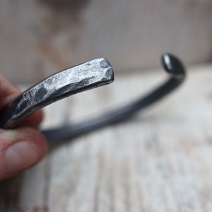 Iron bangle with a hammered texture. Raw, rustic and organic.