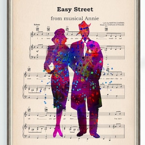 May include: A watercolor illustration of a man and woman in silhouette, superimposed on a sheet of music for the song "Easy Street" from the musical Annie. The music is printed in black and white, and the silhouettes are in shades of pink, purple, and blue.