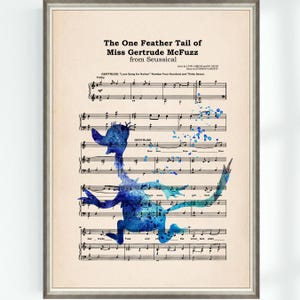 May include: A framed print featuring sheet music with a watercolor illustration of a Seussical character. The image includes the text "The One Feather Tail of Miss Gertrude McFuzz" and a blue watercolor bird-like figure.
