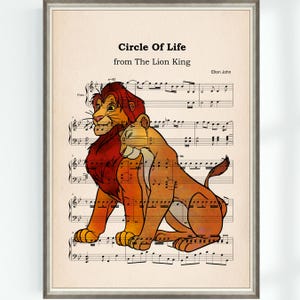 May include: Framed print featuring a colorful illustration of Simba and Nala from The Lion King, set against a backdrop of sheet music. The text "Circle Of Life" and "Elton John" are visible.