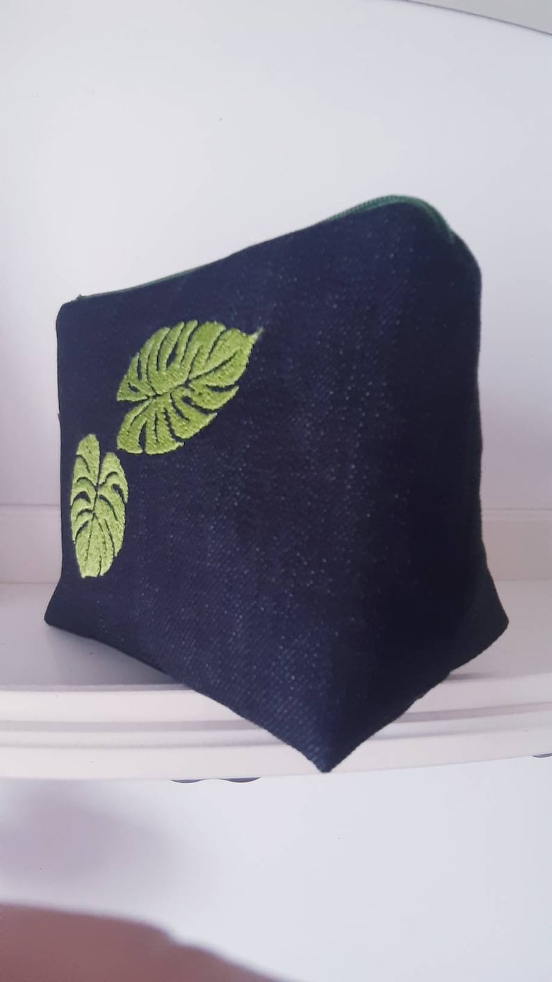 Handmade PRIMULA pochette made of denim fabric with machine embroidery detail