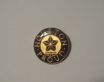 May include: A black and gold circular pin with the text "Boston. Oh. Proud." surrounding a gold star with a small building underneath.