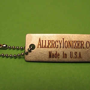 May include: A silver metal keychain with a silver chain and a tag that says "ALLERGYIONIZER.COM Made in U.S.A."