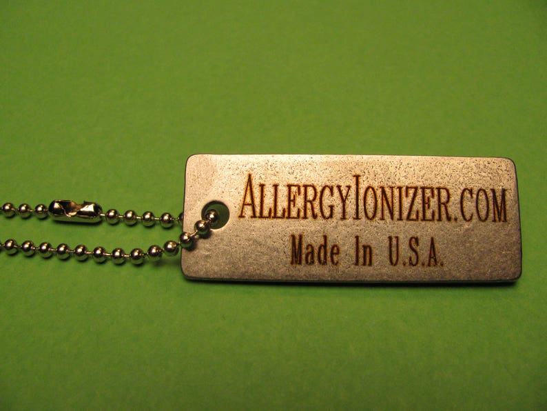 May include: A silver metal keychain with a silver chain and a tag that says "ALLERGYIONIZER.COM Made in U.S.A."