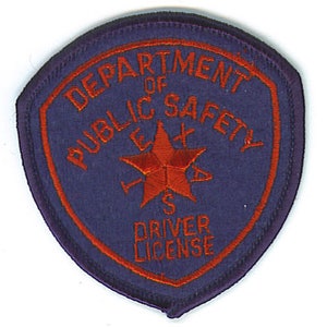 May include: Purple patch with the text "Department of Public Safety" and "Driver License" in orange. A red five-pointed star is in the center.