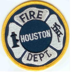 May include: A blue and white embroidered patch with a yellow border. The patch features a fire hydrant, a ladder, and the text "FIRE HOUSTON DEPT."