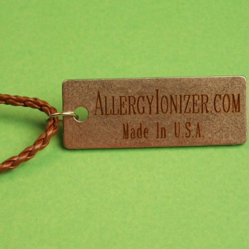 May include: A brown leather cord with a metal tag that reads "ALLERGYIONIZER.COM Made in U.S.A."