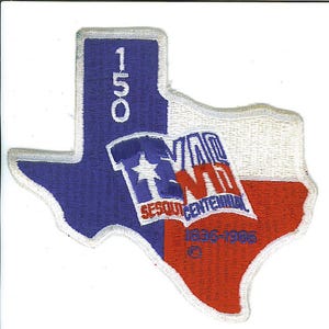 May include: A blue and red embroidered patch shaped like the state of Texas. The patch features the text "Texas Sesquicentennial 1836-1986" and the number "150" in the upper left corner.