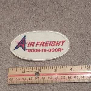 May include: White oval patch with red and blue embroidered text that reads "Air Freight "Door-to-Door"  Made in U.S.A."