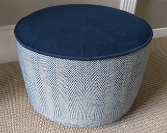 May include: A round blue and white patterned footstool with a dark blue velvet top.