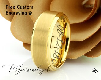 May include: Gold wedding band with a brushed finish and a black engraved inscription that reads "08-12-1800".