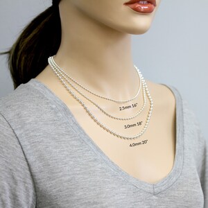 May include: Three silver ball chain necklaces of different lengths and bead sizes. The smallest chain is 16 inches long with 2.5mm beads, the middle chain is 18 inches long with 3.0mm beads, and the largest chain is 20 inches long with 4.0mm beads.