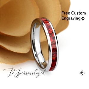 May include: A silver tungsten carbide ring with a red inlay. The ring is on a white background with the text "Free Custom Engraving" and a paw print.