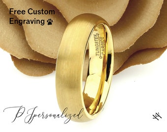 May include: A gold-colored tungsten carbide ring with a brushed finish. The ring has the text "Tungsten Carbide" engraved on the inside. The image also includes the text "Free Custom Engraving" and "PJ Personalized".