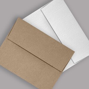 May include: Two envelopes, one brown and one white, with a textured woodgrain pattern. The envelopes are layered on top of each other.