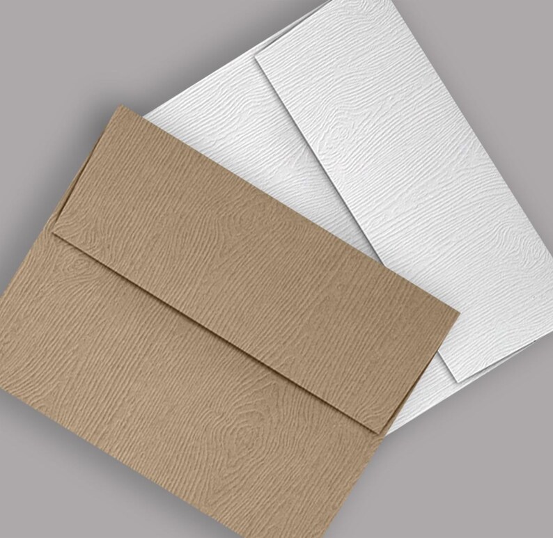 May include: Two envelopes, one brown and one white, with a textured woodgrain pattern. The envelopes are layered on top of each other.
