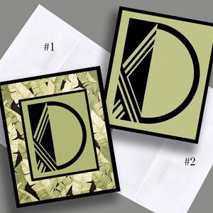 May include: Two square greeting cards with black borders and a geometric design. One card has a green and white leaf pattern, the other has a solid green background. Both cards feature a black geometric design and are placed on white envelopes. The cards are labeled #1 and #2.