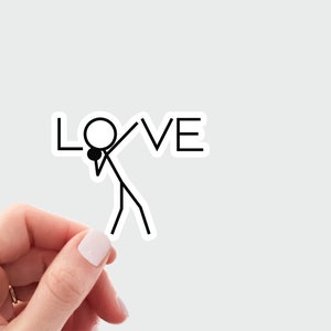 May include: A black and white stick figure with a microphone in its hand, dabbing in front of the word "LOVE" in black text.