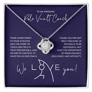 May include: A silver necklace with a crystal knot pendant comes in a blue box with the words "To an amazing Pole Vault Coach" and a message thanking the coach for teaching athletes the skills to be successful, but also the importance of perseverance, resilience, and integrity. The box also includes the words "We Love You!" with a pole vaulting silhouette.