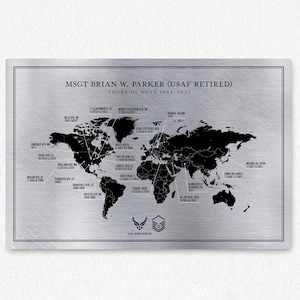 May include: A silver metal plaque with a black world map showing the locations of various Air Force bases. The text "MSGT BRIAN W. PARKER (USAF RETIRED) TOURS OF DUTY 1994-2022" is at the top of the plaque. The U.S. Air Force logo is at the bottom of the plaque.