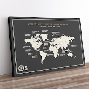 May include: A rectangular wall art print featuring a dark gray background with a cream-colored world map. The text reads CSM BRIAN C. MILLER (ARMY RETIRED) TOURS OF DUTY 1995-2022, with lines pointing to various global locations and dates.