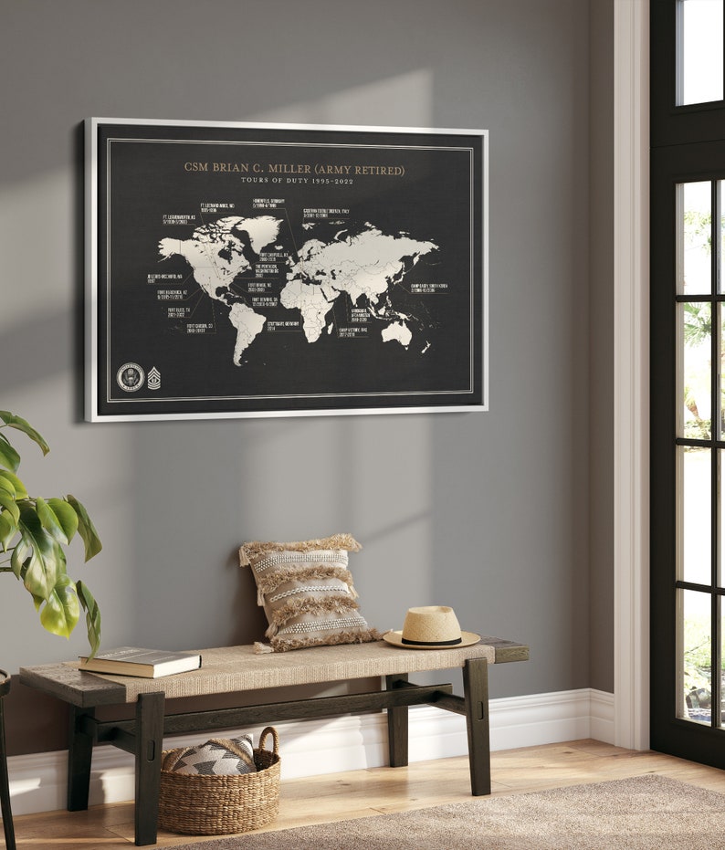 May include: A black and white world map print with a silver frame. The map shows the locations of various military bases around the world. The text at the top of the print reads "CSM Brian C. Miller (Army Retired) Tours of Duty 1995-2022".
