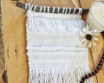 Hand woven wall hanging in white