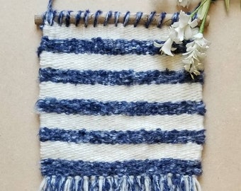 Handwoven wall hanging in blue and cream