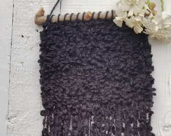 Hand woven wall hanging in black